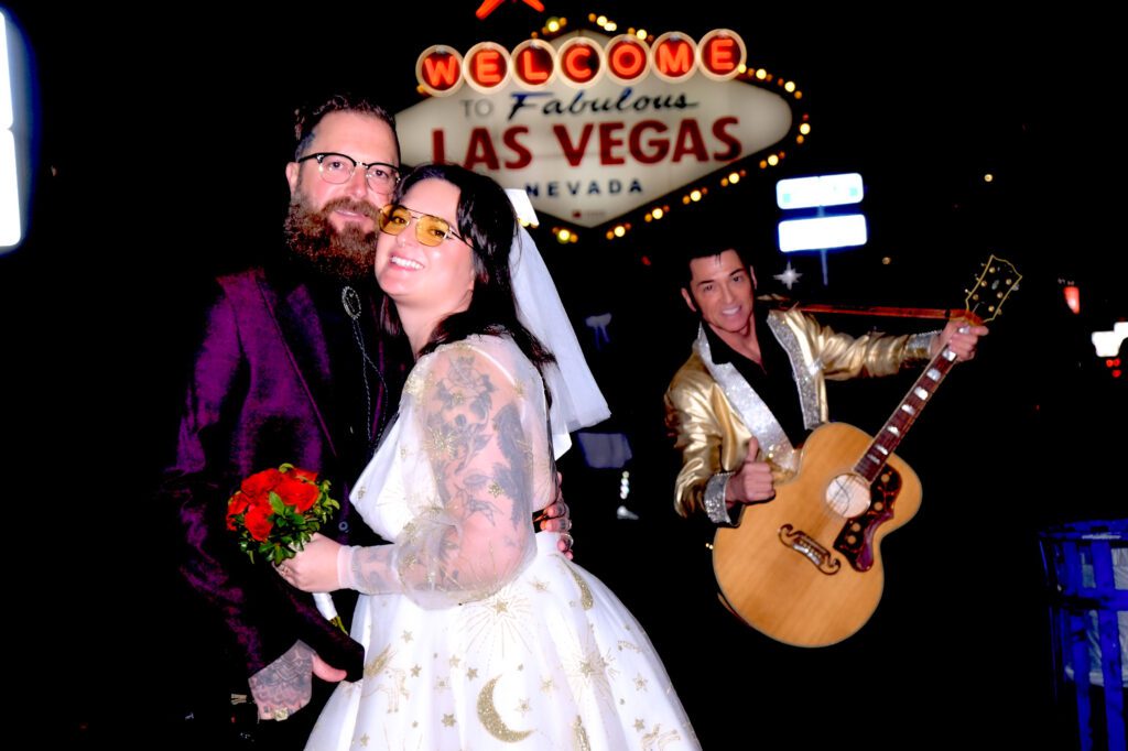 Elvis at the welcome to las vegas sign with bride and groom